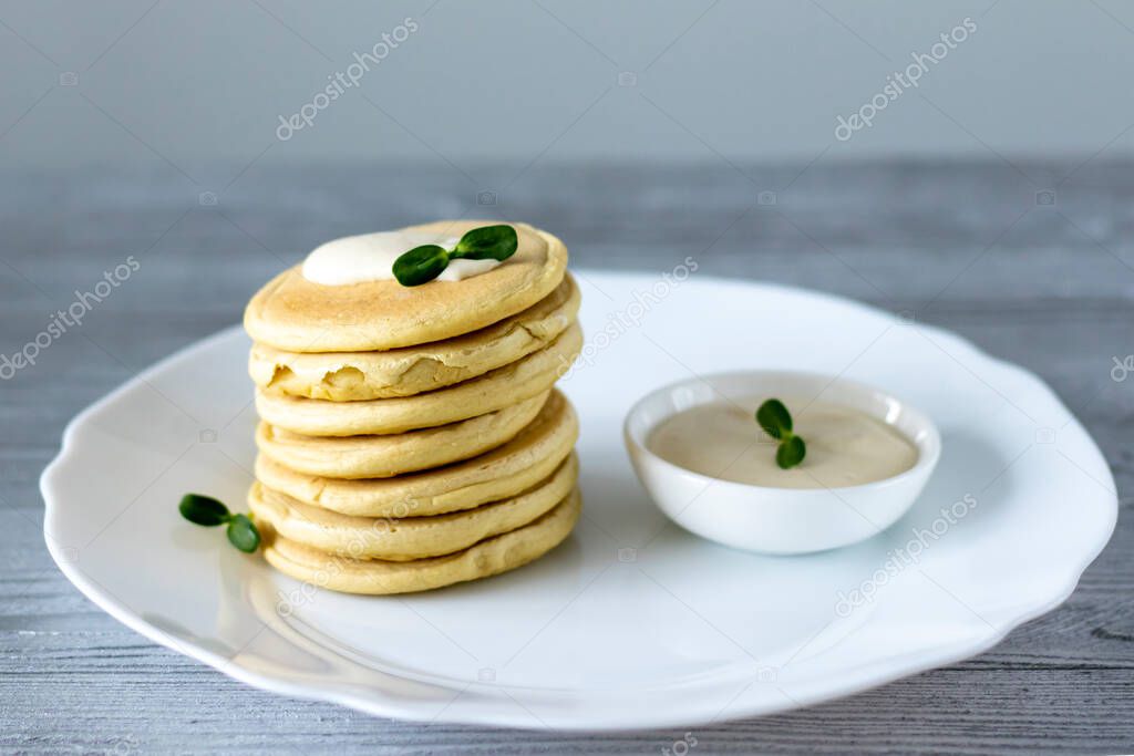 Pea flour pancakes. Fritters with tofu sauce and pea sprouts