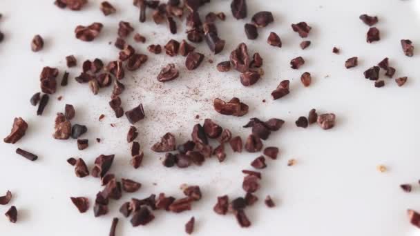 Crushed Cocoa Beans Pouring White Background Selective Focus — Stockvideo