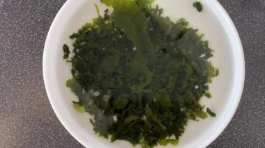 Soaking seaweed wakame in a sachet. Accelerated video 10 minutes. Healthy Seafood. Japanese Cuisine