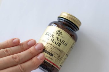 IRPEN, UKRAINE, AUGUST 9 20222, Vitamins for hair skin and nails Solgar Vitamins for women. Glass jar with vitamins and female hands, Illustrative Editorial