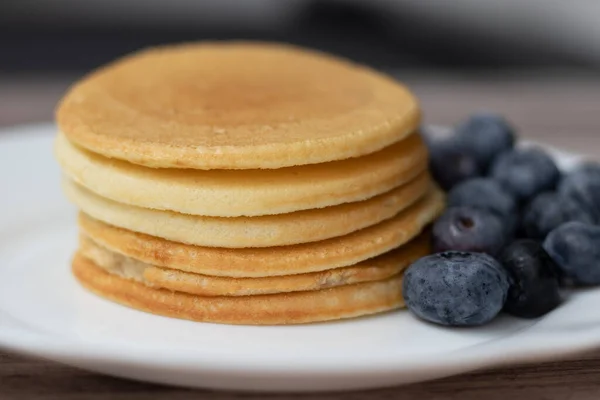 Rice flour and coconut milk pancakes with blueberries. Macro photo, selective focus