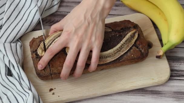 Womans Hand Cuts Freshly Baked Homemade Banana Bread Wooden Background — Stock Video