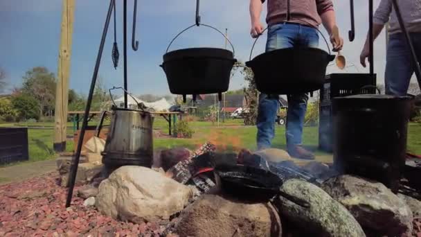 Two Friends Cooking Campfire Cooking Crackling Campfire Stirring Cast Iron — Stock Video