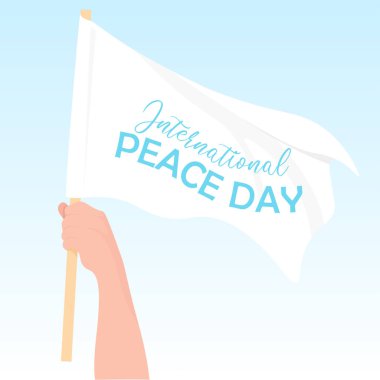 Uluslararası barış gününün şerefine beyaz bayrak tutan bir adam.