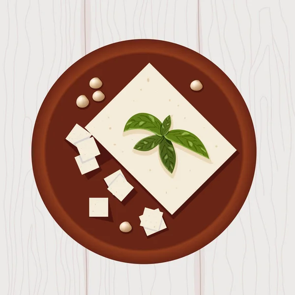 Tofu on wooden plate with soya beans and basil leaves top view