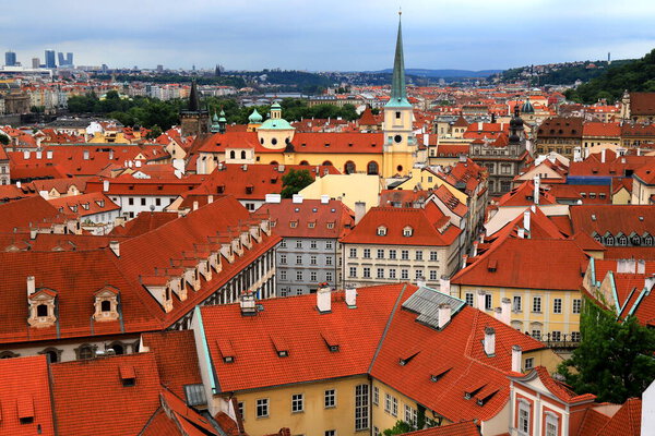 Prague, Czech Republic. Mala Strana, Lesser Town of Prague. Top view of downtown, panorama. Ancient old buildings with red tiled roofs, church, tower, castle