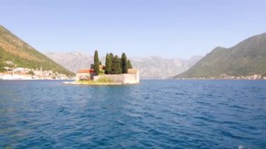 Island of St. George near town Perast in Bay Kotor, Montenegro. Beautiful high mountains near sea in Montenegro. Place for sea tourism, sports, recreation