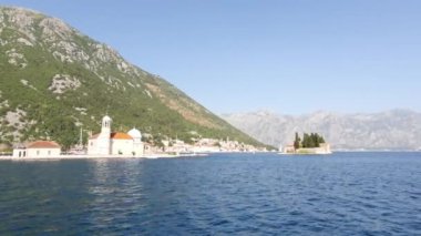 Island of St. George, church on island, Madonna on reef, near town Perast in Bay Kotor, Montenegro. Beautiful high mountains near sea in Montenegro. Place for sea tourism, sports, recre