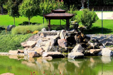 A beautiful landscape park, lake, wooden pavilions in Japanese style. Garden architecture, Uman, Ukraine