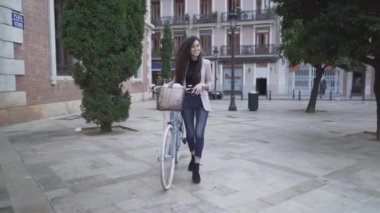 Moroccan Woman With Slender Body And Long Curly Hair Modeling With A Bicycle. Full Body Shot - Horizontal