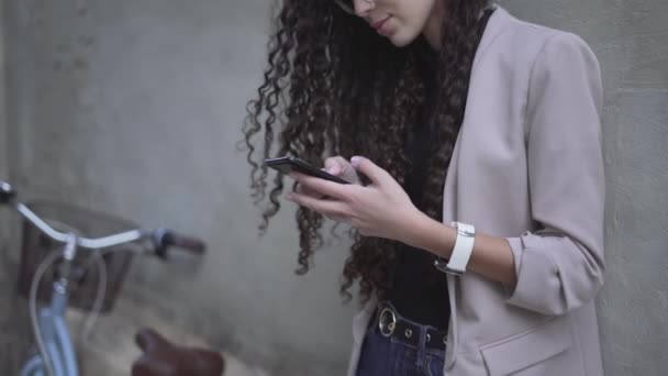 Curly Haired Moroccan Lady Smiling While Looking Her Smartphone Sideview — Stockvideo