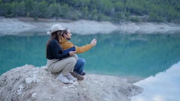 Young Couple Sit Rock Lake Take Selfie Phone Side View — Video