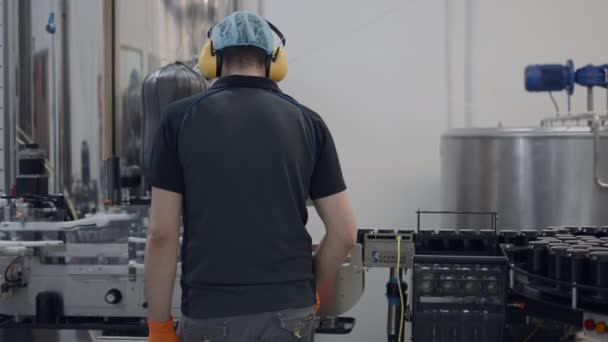 Back View Operator Wearing Hairnet Headphones Working Beer Factory Medium — Video