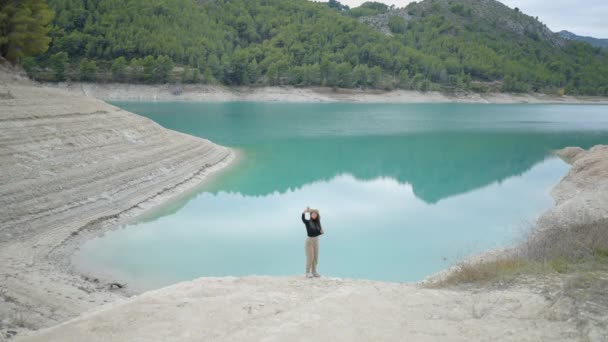 Menina Fica Beira Lago Azul Turquesa Leva Selfie Com Telefone — Vídeo de Stock