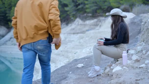 Man Walks Rocks Sits Next Girl Eat Hiking Trip Horizontal — Vídeo de stock