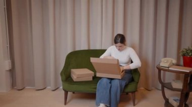 Karton kutularda siparişleri paketleyen bir kadın. Teslimat için kadın girişimci paketleme ürünleri. - Yatay 4K videosu
