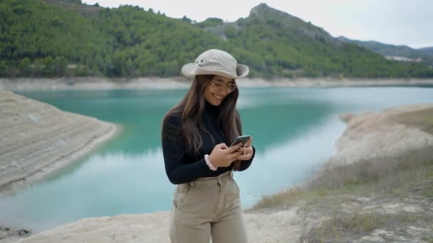 Girl Hat Glasses Takes Selfie Uses Phone Lake Spain Horizontal — Stok Video