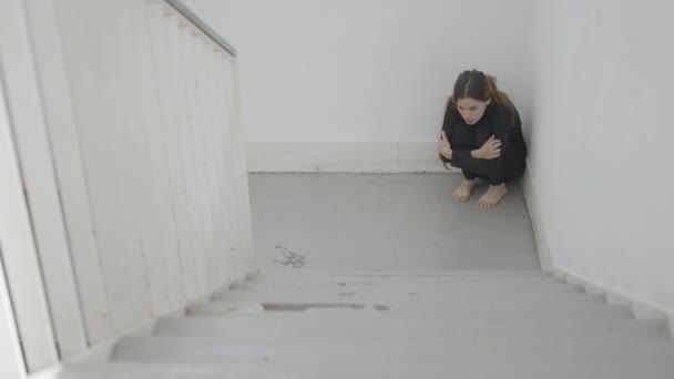 Young Scared Woman Sits Corner Stairwell Arms Legs Horizontal Video — Vídeos de Stock