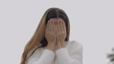 Kameraya doğru peekaboo oynayan genç bayanın yakın görüntüsü - 4K Yatay video