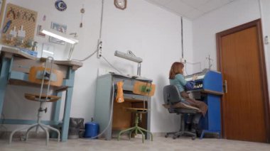 Artisan Jeweler Using Enclosed Grinding Table Polisher - wide shot 4K Horizontal video