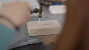 Professional Jeweler Using Blow Torch Melting A Piece Of Metal. Selective Focus Shot 4K Horizontal video