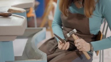 Female Jeweler With A Hammer Strikes On The Silver Billet Of Ring To Make It Round Perfect. Close Up 4K Horizontal video