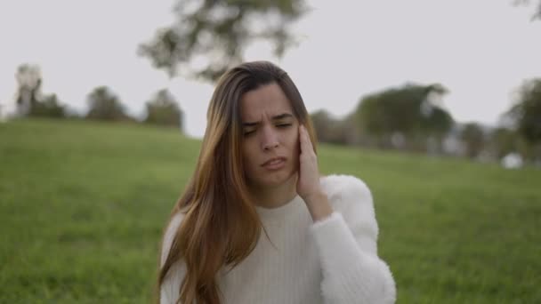 Young Woman Hands Ears Panics Reaction Noise Outdoors Horizontal Video — Stok video