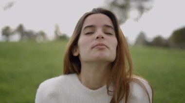 Closeup of face of young woman breathing heavily and laughing outdoors - 4K Horizontal video