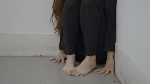 Unrecognizable Woman Sits Corner Hands Bare Feet Floor Horizontal Video — Stockvideo