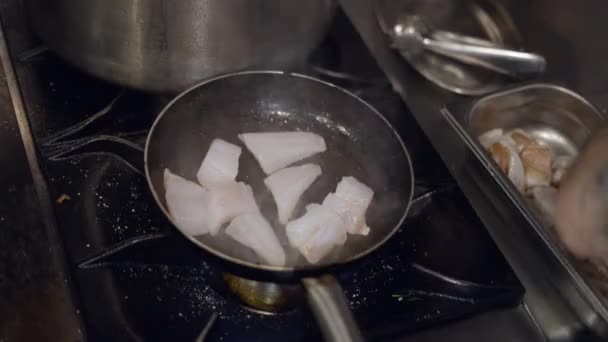 Close View Tattooed Male Chef Placing White Fish Frying Pan — Stockvideo