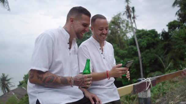 Happy Laughing Male Gay Couple Having Fun Drinking Beer Watching — 图库视频影像