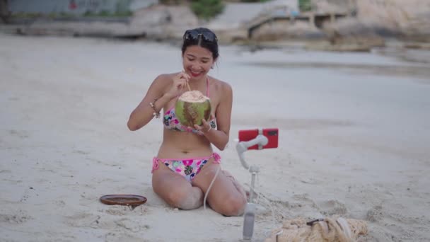 Asian Thai Girl Recording Live Stream Sitting Beach Drinking Coconut — Stock Video