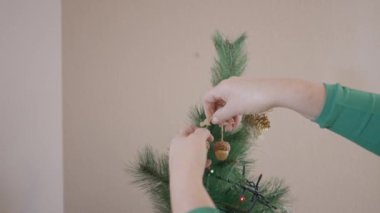 Noel ağacına mısır süsü takan bir kadının kesilmiş görüntüsü. Kapat - Yatay 4K videosu