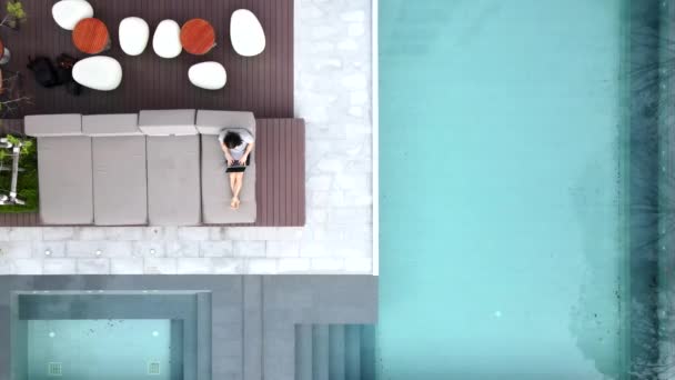 Remote Worker Leisurely Sitting Pool Lounge While Working His Laptop — Stock video