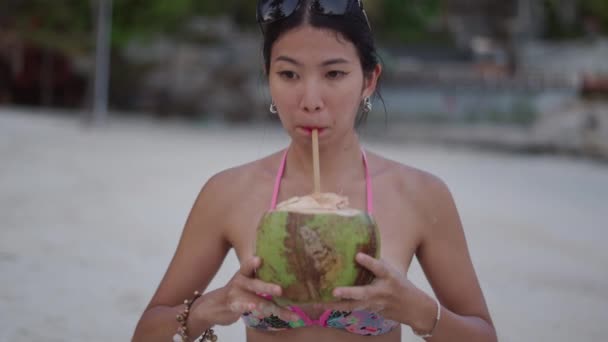 Exotic Asian Thai Girl Drinks Green Coconut Water Straw Beach — Stockvideo
