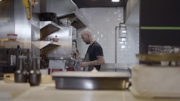 Male Chef Works Restaurant Kitchen Blurry Objects Foreground Horizontal Video — Stok video