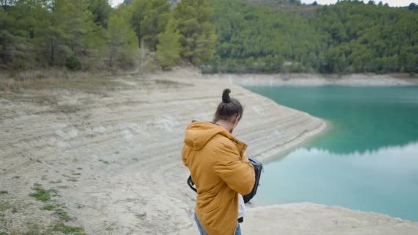 Young Man Takes Camera Out Backpack Photographs Lake Spain Horizontal — ストック動画