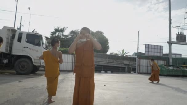 Children Monks Lowered Face Masks Bangkok Streets Slow Motion Horizontal — Video