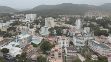 Flying Over Beach Resort Hotels And Accommodations With Swimming Pool In Palma Nova, Mallorca, Spain. - aerial tilt down - Horizontal