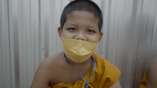 Cute Smiling Young Monk Respiratory Face Mask Close Horizontal Video — Stockvideo