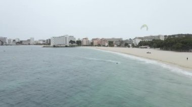 Kitesurfing at the beautiful beach in Mallorca, Spain - aerial drone shot - Horizontal