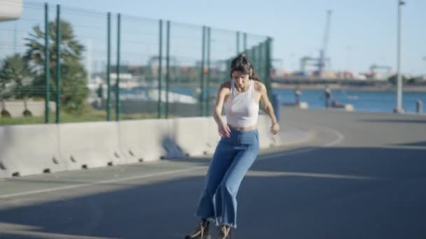Tracking Slomo Shot Young Dark Haired Girl Roller Skating Outdoors — Vídeos de Stock