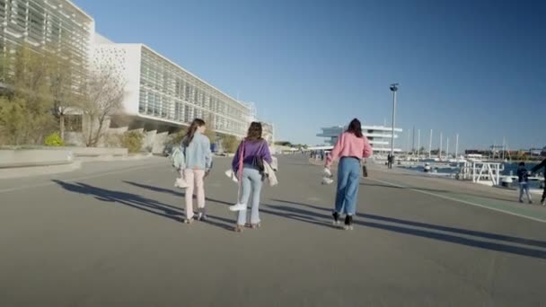 Three Girls Roller Skate Road Water While Holding Shoes Horizontal — Αρχείο Βίντεο