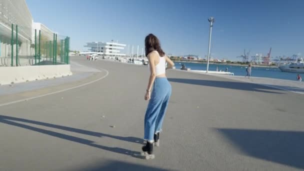 Lone Girl Jeans White Top Roller Skates Harbor Sunlight Horizontal — Stockvideo