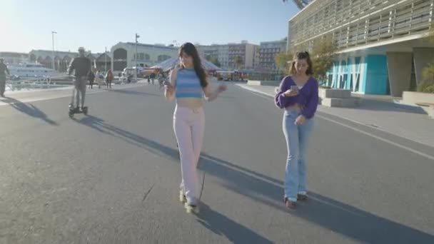 Frontal View Teenage Girls Using Phones While Roller Skating Sun — Stok video