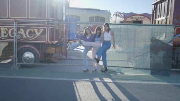 Three Smiling Girls Metal Fence Lift Roller Skates Push Horizontal — стоковое видео