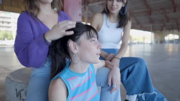 Close View Young Women Sitting Talking Fixing Hair Outdoors Horizontal — Video