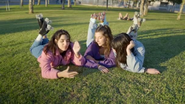Teenage Girls Colorful Clothes Lying Lawn Take Selfie Phone Horizontal – stockvideo