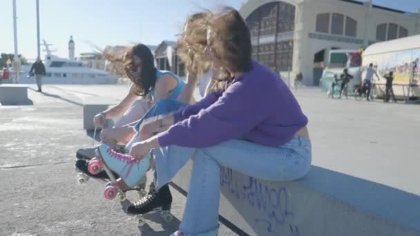 Side View Three Girls Tying Roller Skates Wind Hair Horizontal — Vídeos de Stock
