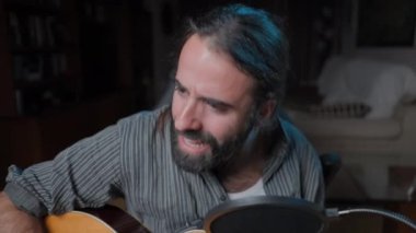 Attractive songwriter on his 30s playing and singing an emotional song - Close up shot